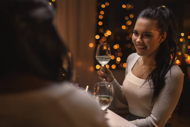 happy woman drinking wine at christmas dinner - Foto, imagen
