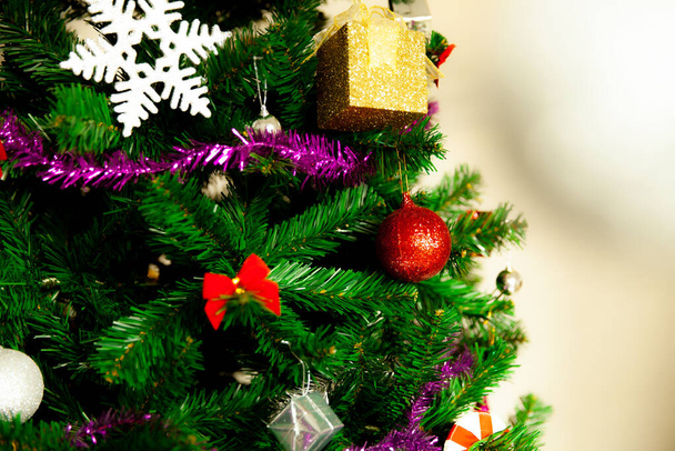 Christmas Tree with colorful decoration on cream background - Valokuva, kuva