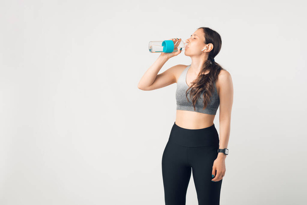 Photo of young woman hydrating over white wall - Foto, Imagen