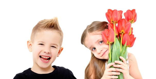 Portrait of smiling boy and cute girl with tulips isolated on white background - Foto, imagen