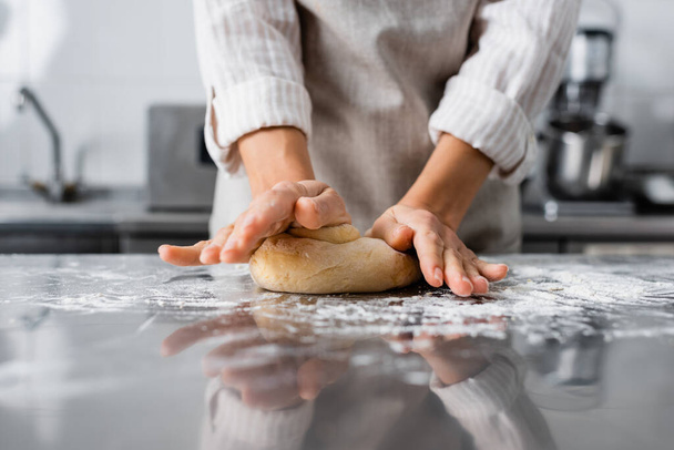 Cropped view of chef making dough near flour on table in kitchen  - Fotoğraf, Görsel