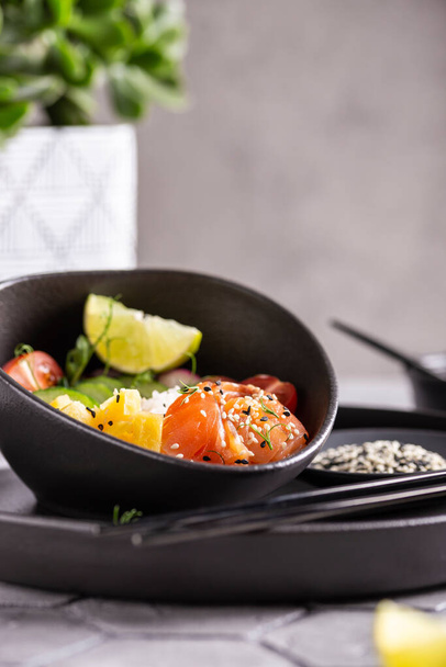 Dinner with fresh poke salad with salmon - Photo, image