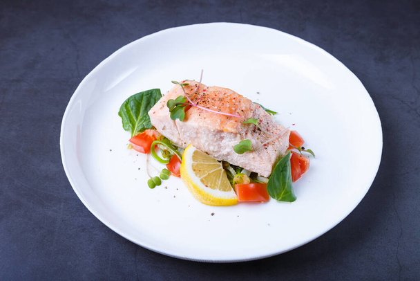 Trout (salmon) with vegetables, lemon and microgreens, cooked by the confit method. Traditional French dish. Step by step. Close-up. - 写真・画像