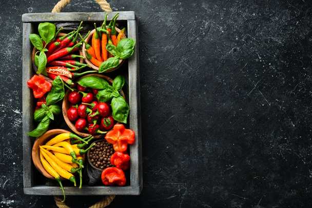 Spices in a wooden box: basil, pepper, oil, paprika, herbs. Food background. Top view. - Foto, immagini