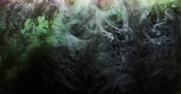 Green smoke on black ink background, colorful fog, abstract swirling emerald ocean sea, acrylic paint pigment underwater - Valokuva, kuva