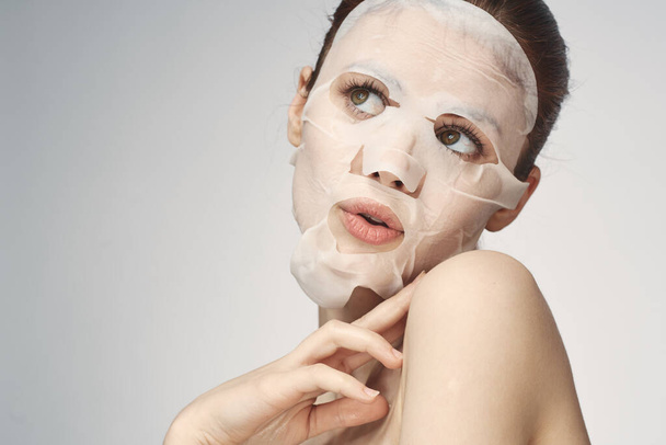 woman with bare shoulders face mask skin care procedures - Foto, Imagem