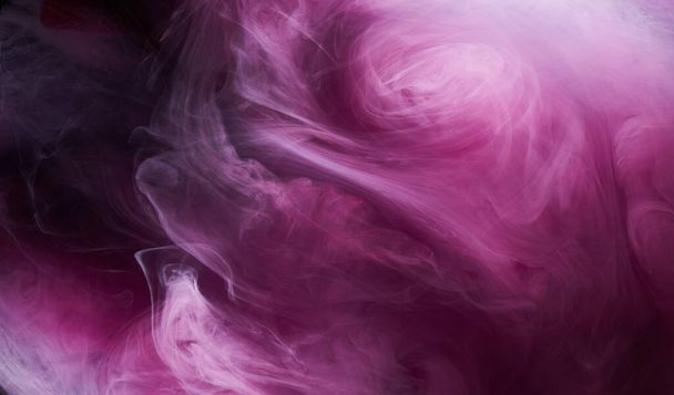 Pink smoke on black ink background, colorful fog, abstract swirling touch ocean sea, acrylic paint pigment underwater - 写真・画像