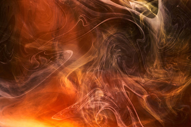 Orange smoke on black ink background, colorful fog, abstract swirling ocean sea, acrylic paint pigment underwater - Foto, Bild