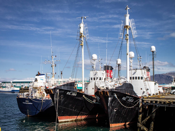 Reykjavik, Iceland - June 12, 2021: Three black fish cutters moored at a pier in Old Reykjavik Harbour, on a bright sunny day.  - Photo, Image