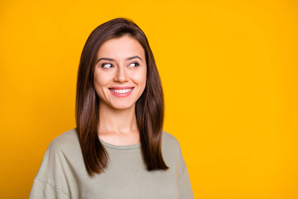 Portrait of young attractive lovely pretty smiling cheerful happy girl look copyspace isolated on yellow color background. - Valokuva, kuva