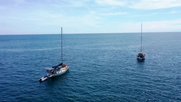 Filmagem aérea de um veleiro Dois veleiros atracados no mar. Belo dia de verão claro e ensolarado em Bali - Filmagem, Vídeo
