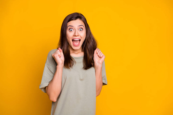 Photo of young happy excited smiling cheerful shocked amazed girl win lottery isolated on yellow color background. - Foto, Bild