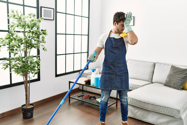 Young hispanic man cleaning at home - Foto, Imagem