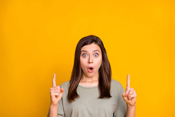 Photo of young lovely pretty shocked surprised amazed girl point fingers up in copyspace isolated on yellow color background. - Φωτογραφία, εικόνα