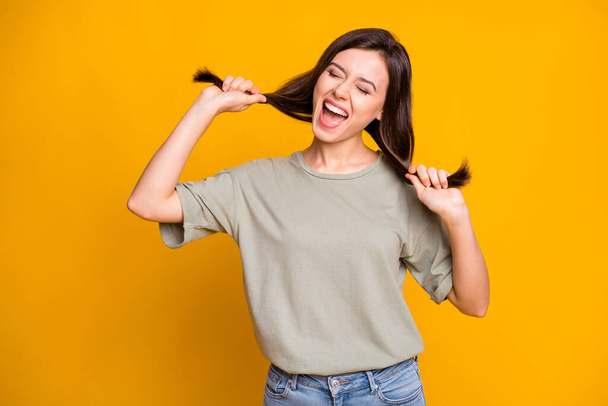 Photo of young beautiful pretty happy positive smiling crazy girl dancing pull hair isolated on yellow color background. - Foto, Imagem