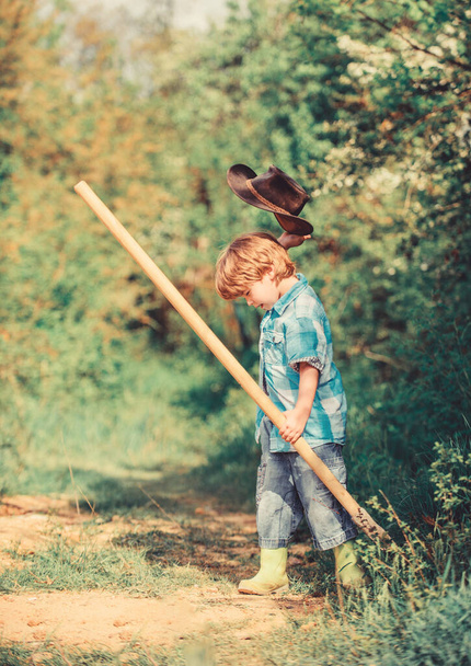Little helper working in garden. Cute child in nature having fun with shovel. I want to find treasures. Happy childhood. Adventure hunting for treasures. Little boy with shovel looking for treasures - Zdjęcie, obraz