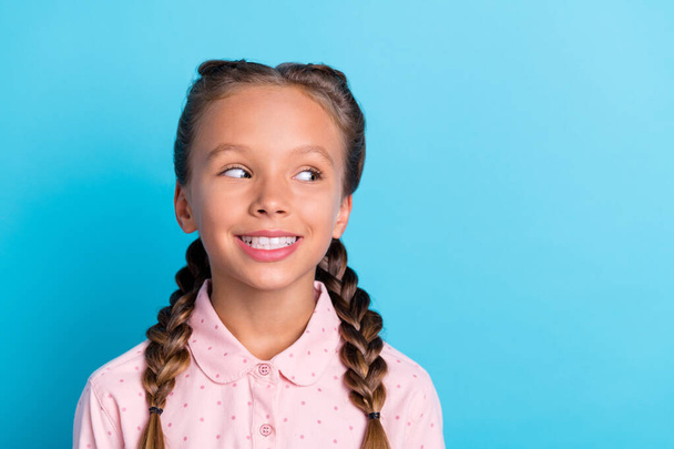 Photo of young cheerful little girl happy positive toothy smile dream look empty space isolated over blue color background. - Foto, Bild