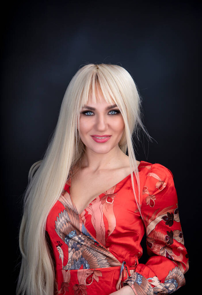 portrait of a beautiful blonde girl in a red dress - Fotografie, Obrázek