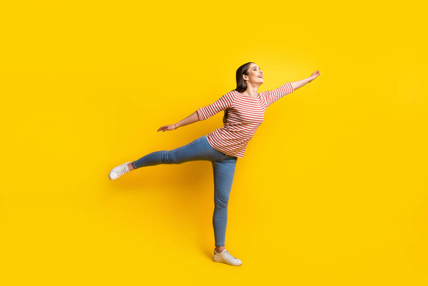 Full length body size view of attractive cheerful girl flying far away trip like plane having fun isolated over bright yellow color background. - Fotoğraf, Görsel