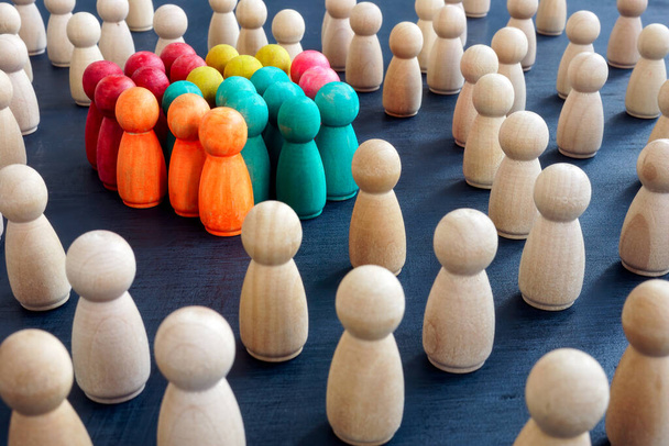 Social inclusion concept. Group color figurines and wooden ones. - Foto, immagini