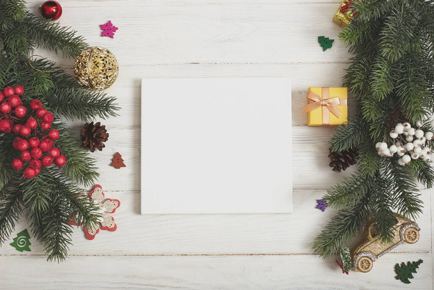 Festive Christmas greeting card with decorated fir tree and copy space for your xmas greetings. Top view flat lay - 写真・画像