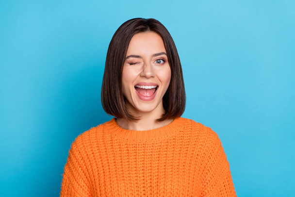Portrait of attractive flirty cheerful girl winking good mood isolated over vibrant blue color background. - Фото, изображение