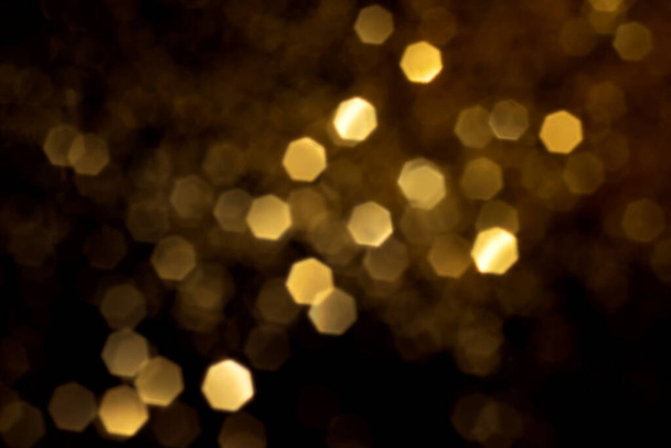 Golden blurred bokeh lights on black background - Zdjęcie, obraz