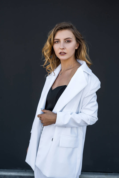 modern pretty woman in white suit isolated on black background. female portrait. - Photo, Image