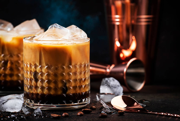 White russian cocktail, trendy alcoholic drink with vodka, coffee liqueur, cream and ice, dark background, bar tools - Foto, immagini