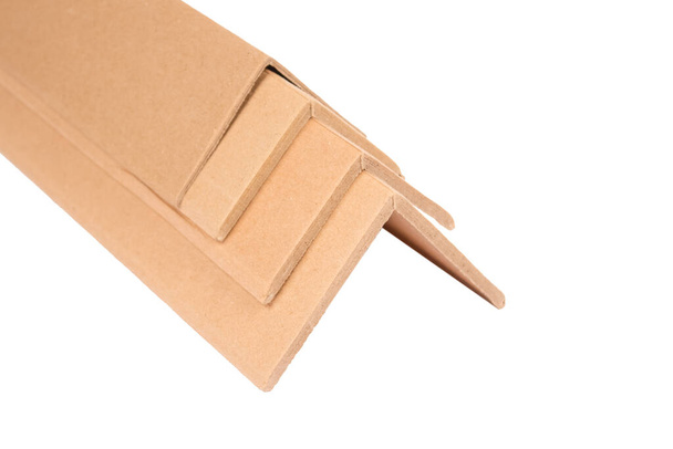 Cardboard angular edge protectors for protection goods while transportation isolated on white. Transport packaging for protecting goods against damage in transit. Sustainable packaging concept - Photo, Image