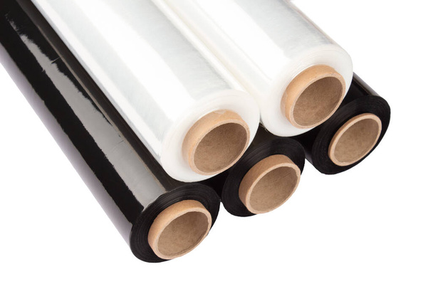 Set of plastic packaging materials - plastic white and black stretch film rolls isolated on white. PE packaging materials. Selective focus - Photo, Image