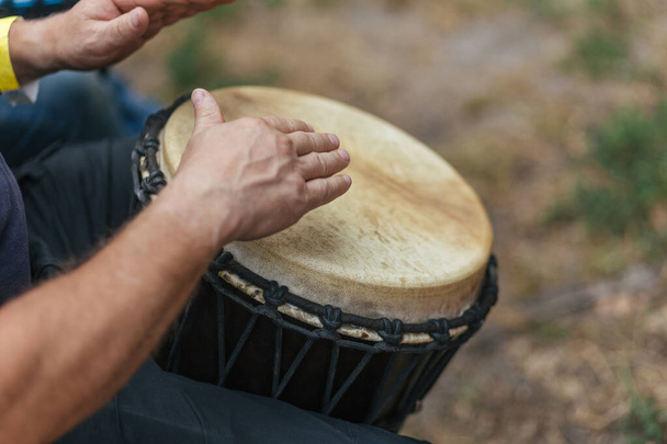 musician playing djembe, performing at a concert - Photo, Image