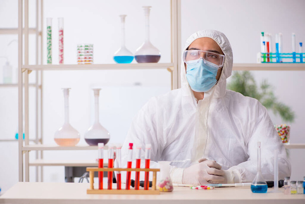 Young male chemist in drugs syntesis concept - Photo, Image