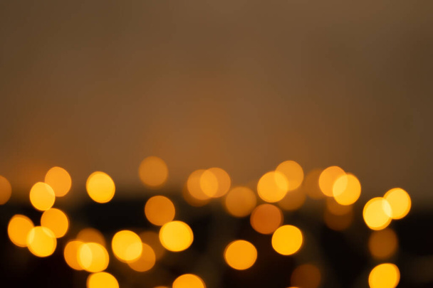 Defocused bokeh lights on black background, an abstract naturally blurred backdrop - Foto, Imagen