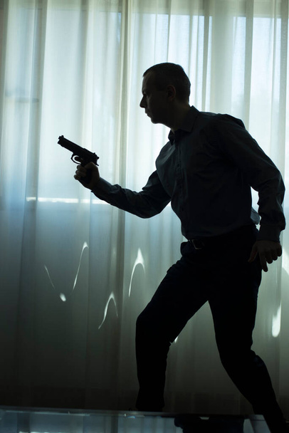 Spy thriller book cover design with man holding pistol gun. - Fotografie, Obrázek