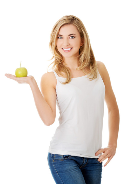 Woman with a green apple - Photo, Image