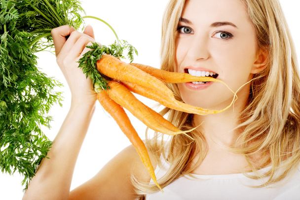 Young woman with the carrots - Photo, Image