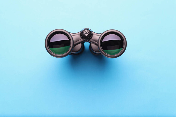Binoculars equipment placed on blue background with shadow - Photo, Image