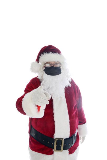Papá Noel dice que use una máscara. Santa Claus usa una máscara facial médica para ayudar a prevenir la contracción del Coronavirus. Aislado sobre blanco. Espacio para texto. Covid-19 es peligroso. Es una Navidad COVID-19. Se requiere mascarilla facial incluso después de la vacunación con covid-19. - Foto, Imagen