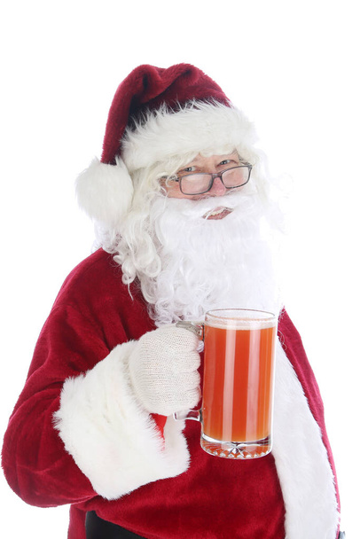 Santa Claus enjoys a mug of Michelada. Spicy Mexican Beer and Tomato Juice Cocktail. Michelada is the Mexican Bloody Mary. Mexican alcohol cocktail Michelada with dark beer and Tomato juice. Mexican alcohol cocktail michelada with beer & lime juice. - Photo, Image