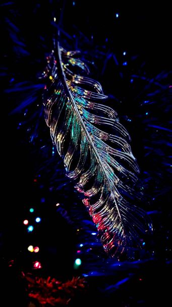 A Christmas tree toy in the form of a bird's feather - Zdjęcie, obraz