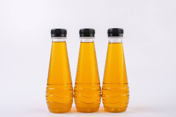 fruit juice plastic cold bottles of water with drops isolated on white background,  - Valokuva, kuva