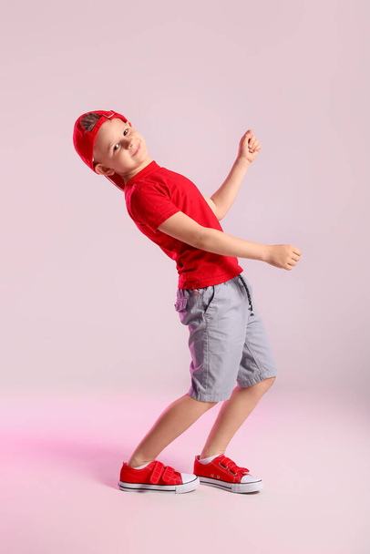 Cute little boy dancing on grey background - Photo, image