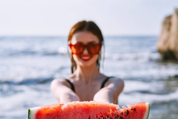 cheerful pretty woman in black swimsuit watermelon fashion travel - Foto, immagini