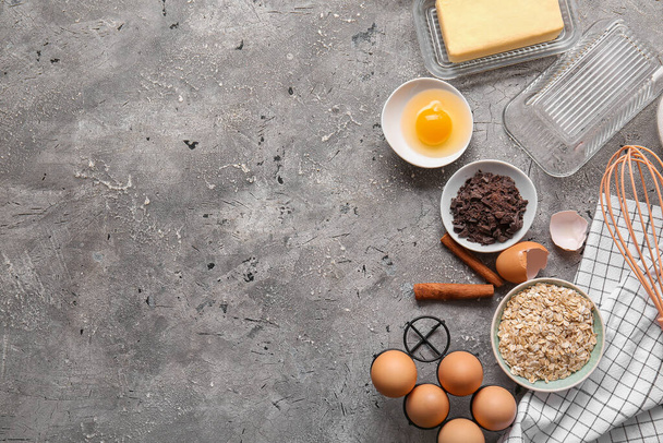Ingredients for preparing homemade cookies on grey background - Valokuva, kuva