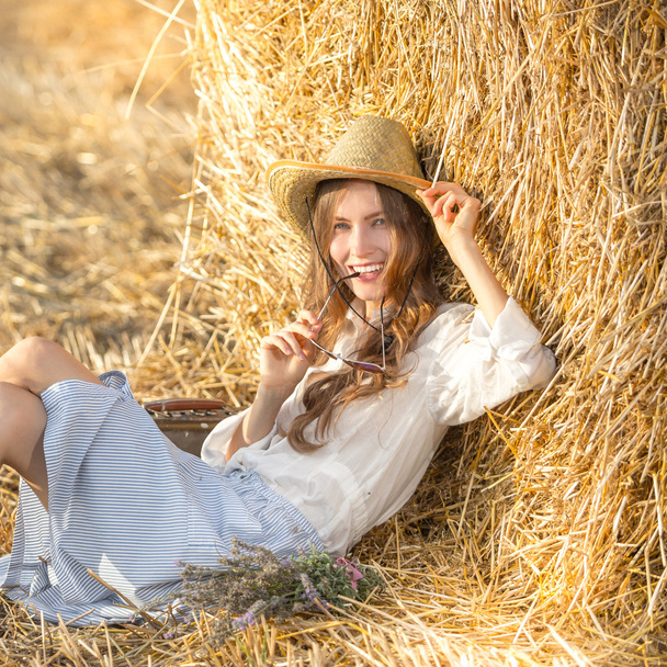 Attractive young woman relaxing outdoors - 写真・画像