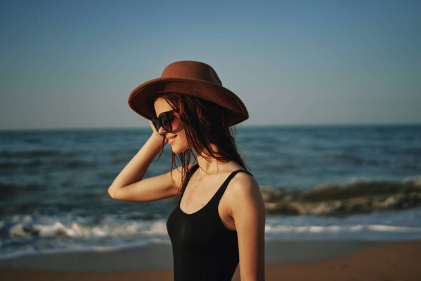 pretty woman in hat walking on the beach ocean travel - 写真・画像