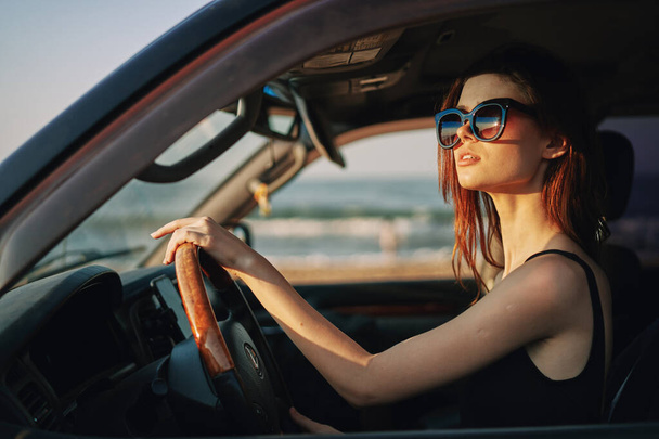 pretty woman in sunglasses driving a car trip - Фото, изображение