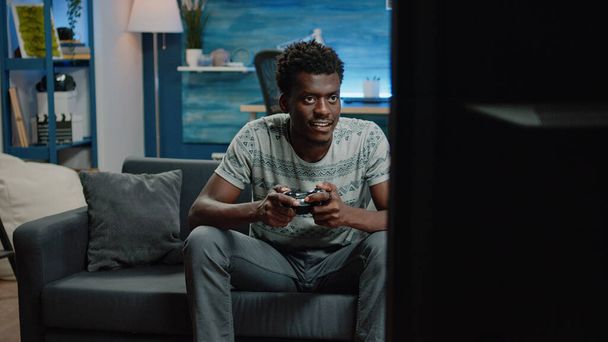 Person playing virtual video games and holding joystick - Valokuva, kuva