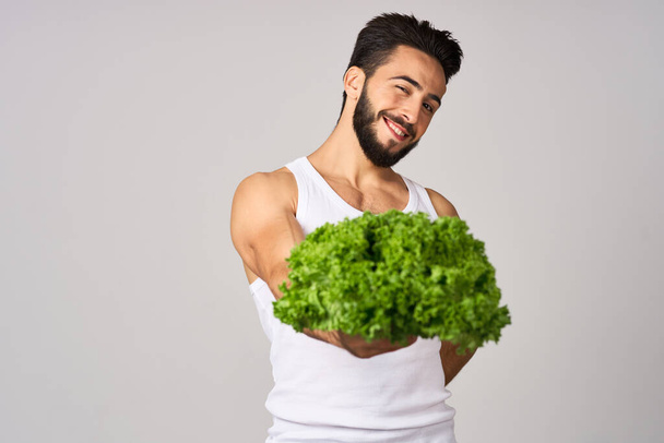 cheerful man in a white t-shirt lettuce leaves healthy food - Zdjęcie, obraz